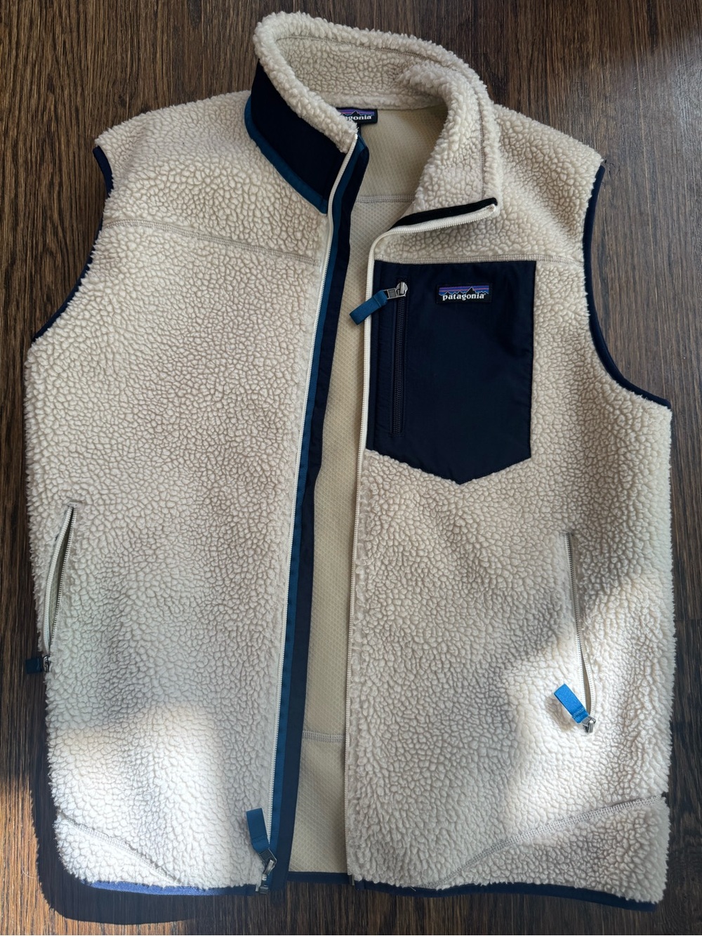 Patagonia mens Cream Sherpa Vest with Navy Chest Pocket Trim